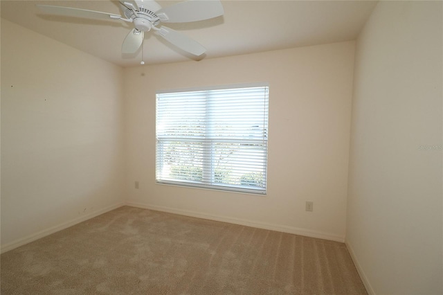 carpeted spare room with ceiling fan