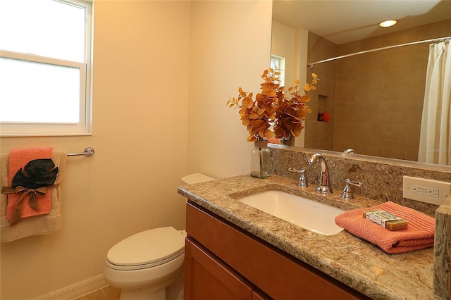 bathroom with vanity, curtained shower, and toilet