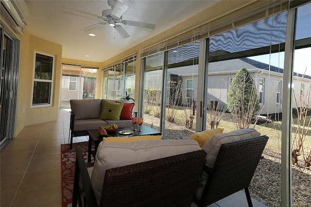 sunroom / solarium featuring ceiling fan and a wall unit AC