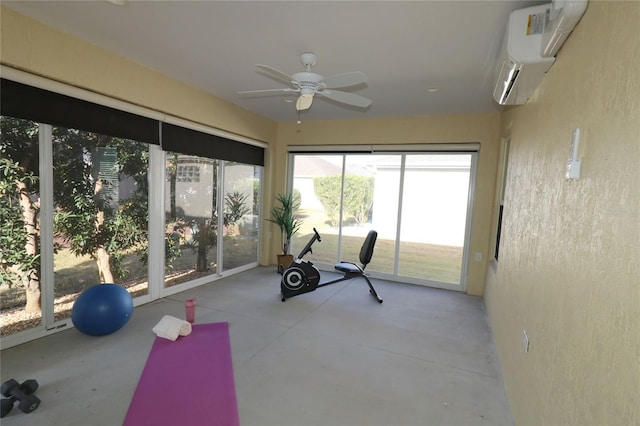 exercise room featuring a wall mounted air conditioner and ceiling fan