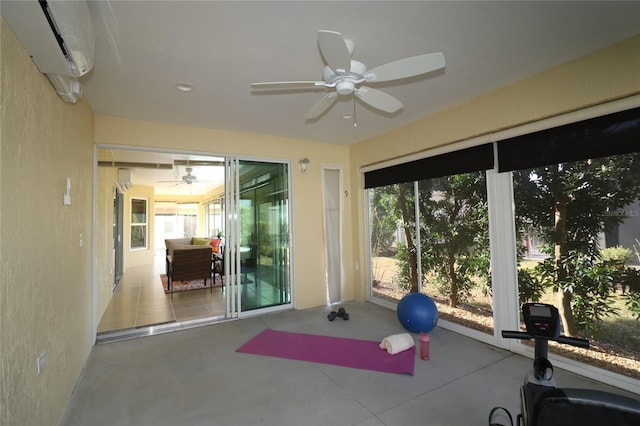 exercise room with ceiling fan