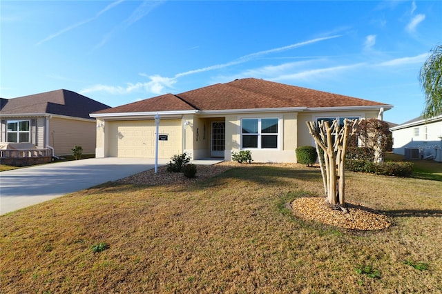 ranch-style house featuring central AC, a garage, and a front yard