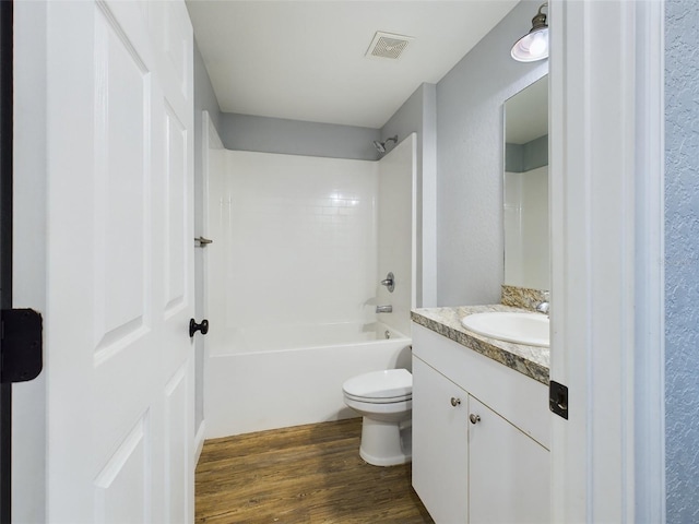 full bathroom featuring vanity, toilet, tub / shower combination, and hardwood / wood-style floors