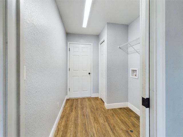 laundry area featuring hookup for a washing machine and wood-type flooring