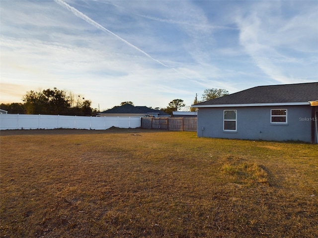 view of yard at dusk