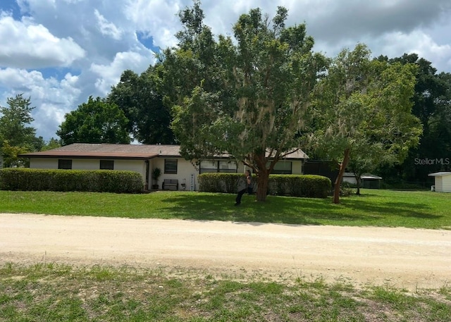 ranch-style home with a front lawn