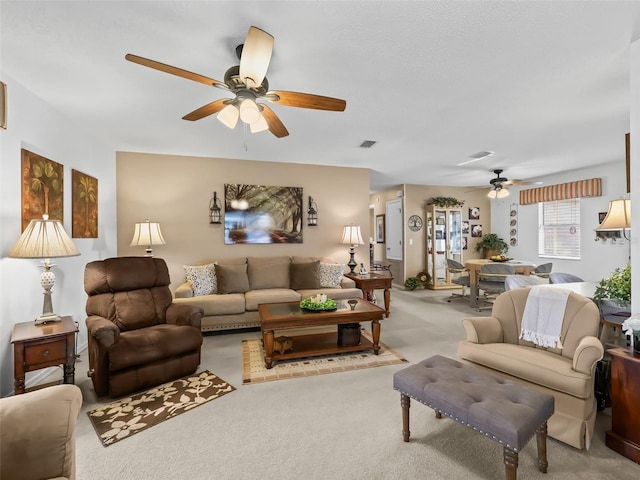 carpeted living room featuring ceiling fan