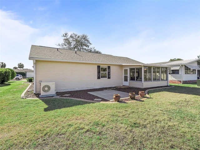 back of house with ac unit, a lawn, a sunroom, and a patio area