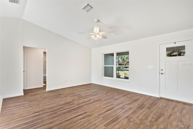 interior space featuring baseboards, visible vents, ceiling fan, wood finished floors, and vaulted ceiling