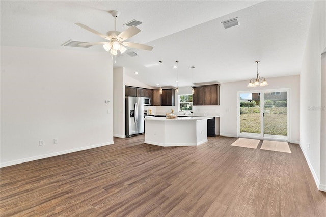 kitchen with appliances with stainless steel finishes, a center island, open floor plan, and dark brown cabinetry