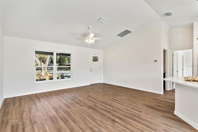 unfurnished living room with ceiling fan, lofted ceiling, and dark hardwood / wood-style floors