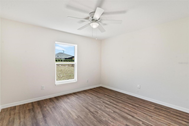 spare room with ceiling fan, baseboards, and wood finished floors