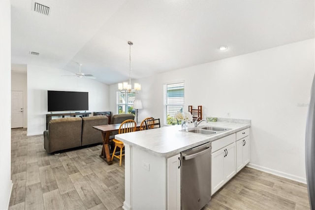 kitchen featuring decorative light fixtures, white cabinetry, dishwasher, sink, and kitchen peninsula