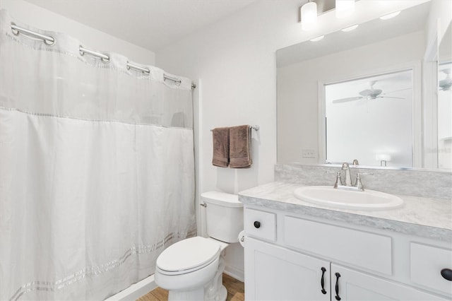 bathroom with vanity, ceiling fan, and toilet