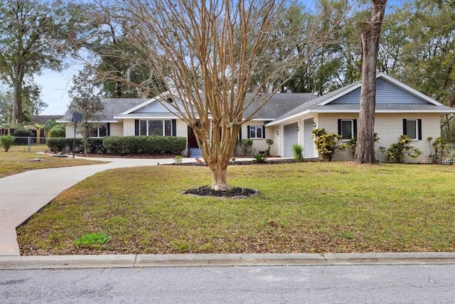 ranch-style house with a garage and a front lawn