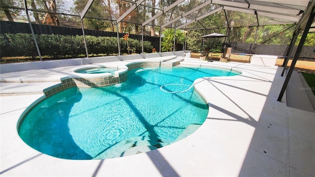 view of pool featuring glass enclosure, a patio area, and a fenced backyard