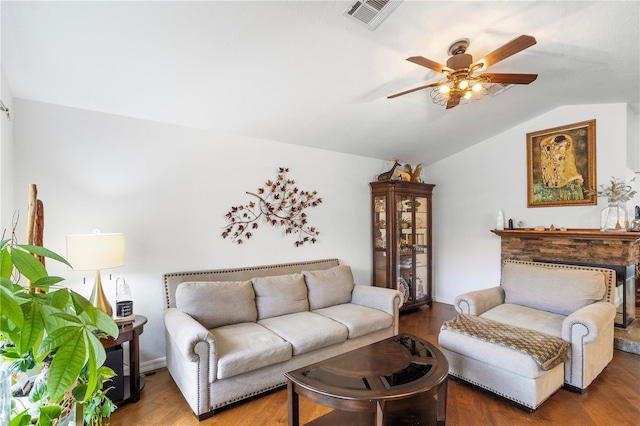 living room featuring a ceiling fan, lofted ceiling, wood finished floors, and visible vents