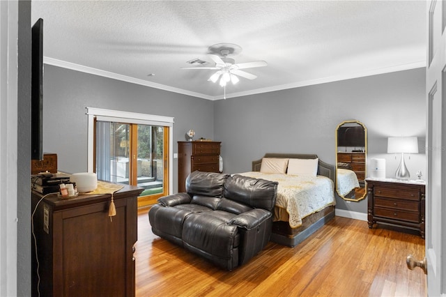 bedroom featuring light wood finished floors, crown molding, and access to exterior