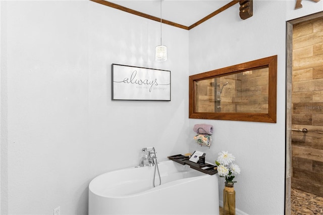 bathroom featuring a tile shower, ornamental molding, and a freestanding tub