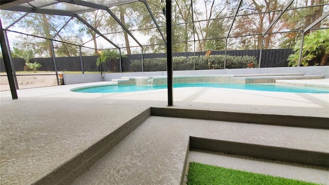 view of swimming pool with a patio area, a fenced in pool, glass enclosure, and a fenced backyard