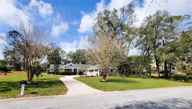 ranch-style home with a garage, concrete driveway, and a front lawn