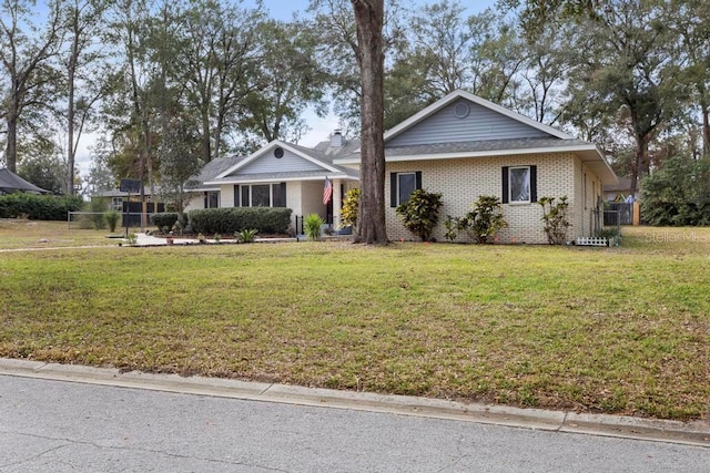 ranch-style home with a front lawn and brick siding