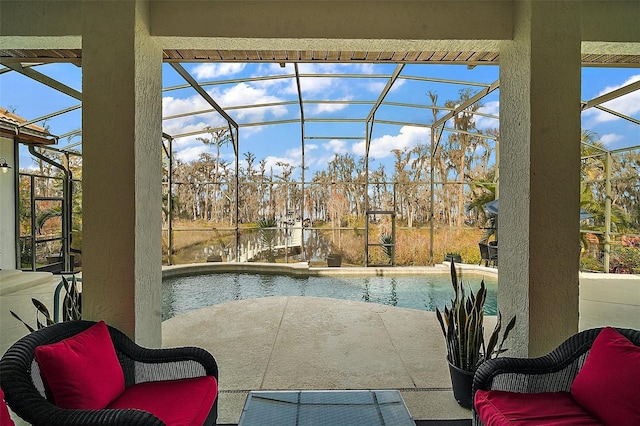 view of pool featuring a patio area and glass enclosure