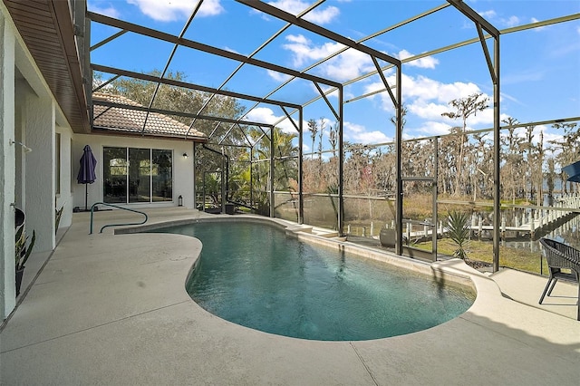 view of swimming pool featuring a lanai and a patio