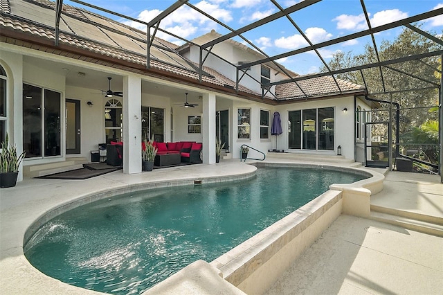 view of swimming pool featuring a patio, a lanai, an outdoor hangout area, and ceiling fan