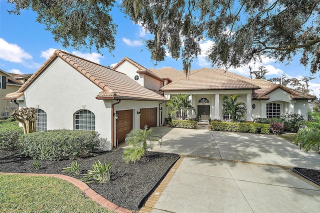 mediterranean / spanish-style home with a garage