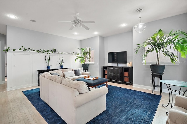 living room featuring hardwood / wood-style floors and ceiling fan