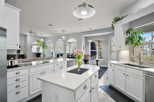 kitchen with black electric cooktop, sink, dishwasher, and white cabinets