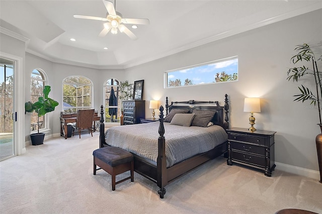 carpeted bedroom with ornamental molding, access to outside, ceiling fan, and a tray ceiling