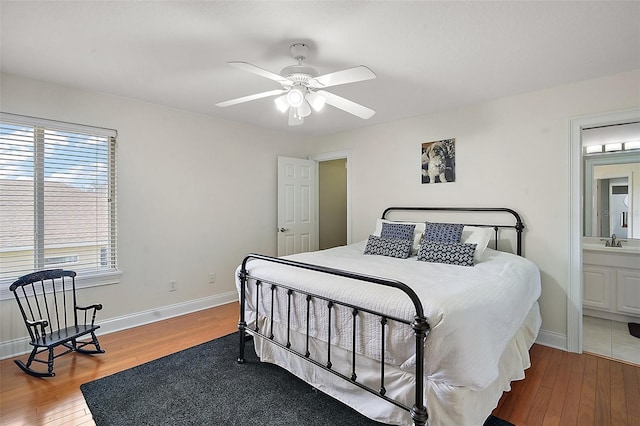 bedroom featuring wood-type flooring, sink, connected bathroom, and ceiling fan