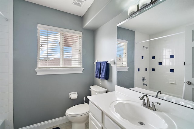 full bathroom with vanity, tiled shower / bath, plenty of natural light, and toilet