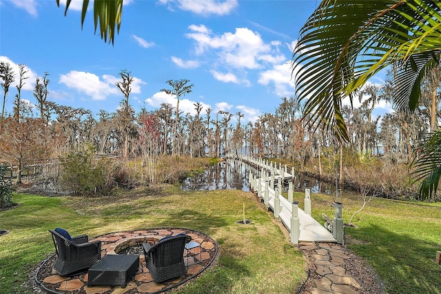 view of yard with a fire pit and a water view