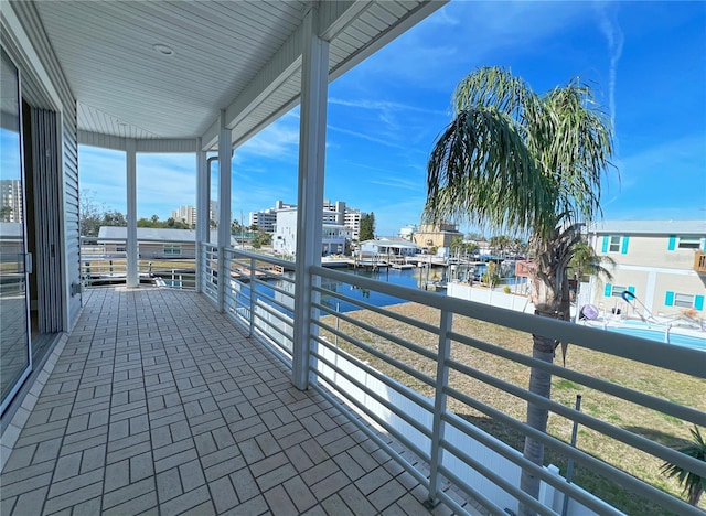 view of patio with a water view and a balcony