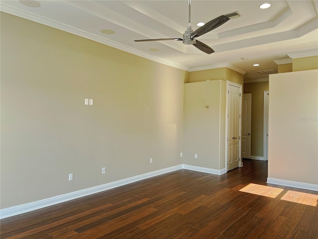 unfurnished room with dark wood-type flooring, ceiling fan, crown molding, and a raised ceiling