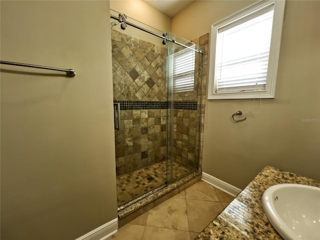 bathroom featuring tile patterned flooring, an enclosed shower, and vanity