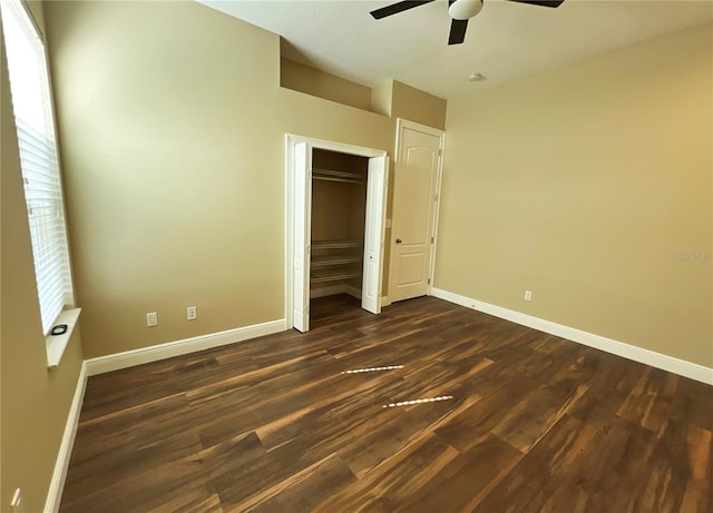 unfurnished bedroom featuring a closet, dark hardwood / wood-style floors, and ceiling fan