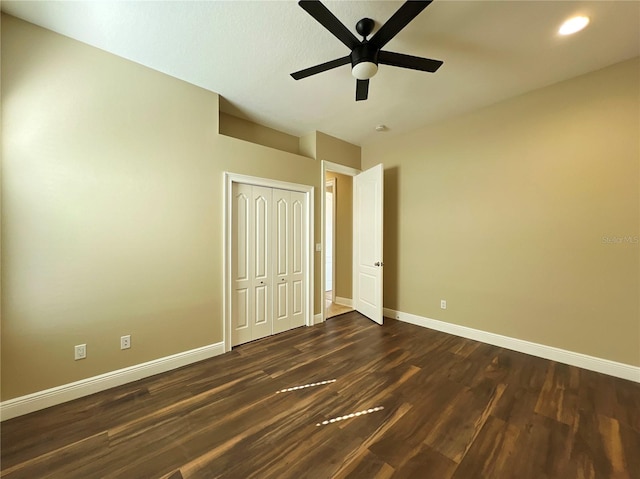 unfurnished bedroom with ceiling fan, dark hardwood / wood-style flooring, and a closet