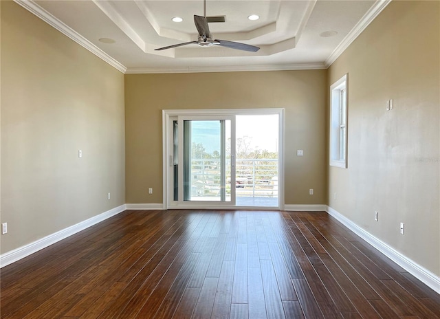 unfurnished room featuring dark hardwood / wood-style flooring, crown molding, a raised ceiling, and ceiling fan