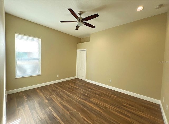 unfurnished room featuring ceiling fan and dark hardwood / wood-style flooring