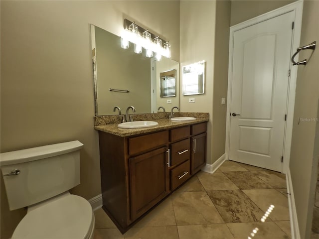 bathroom with vanity, tile patterned flooring, and toilet