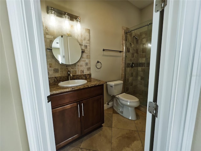 bathroom with a tile shower, decorative backsplash, vanity, toilet, and tile patterned floors