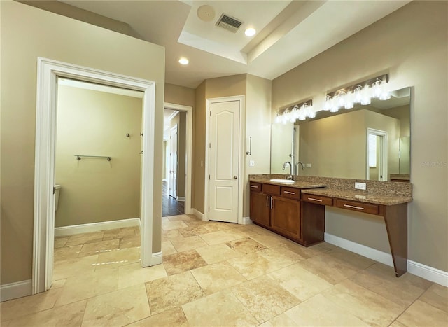 bathroom with vanity and a raised ceiling