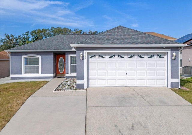 ranch-style home featuring cooling unit and a garage