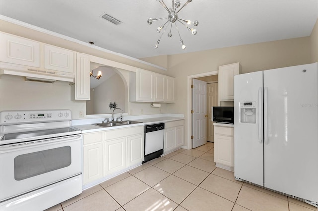 kitchen with light tile patterned flooring, sink, a chandelier, white appliances, and white cabinets