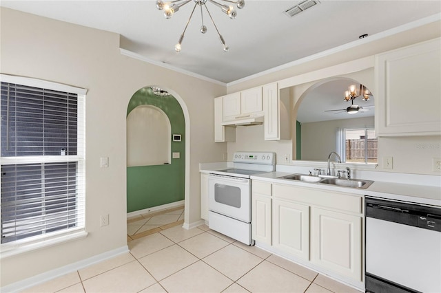 kitchen with sink, white cabinets, light tile patterned floors, crown molding, and white appliances