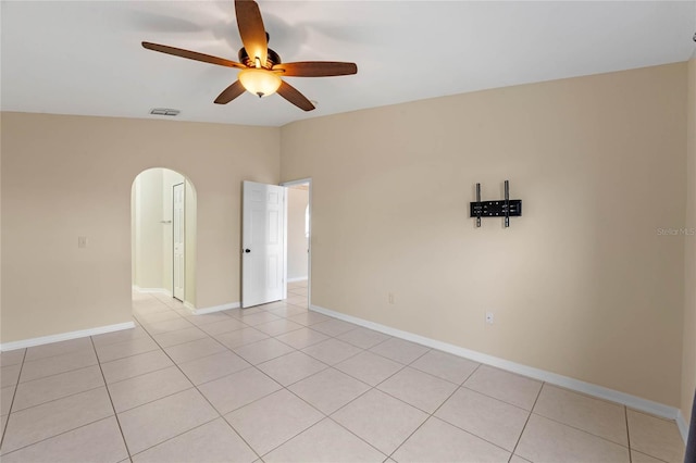 spare room featuring ceiling fan, vaulted ceiling, and light tile patterned floors